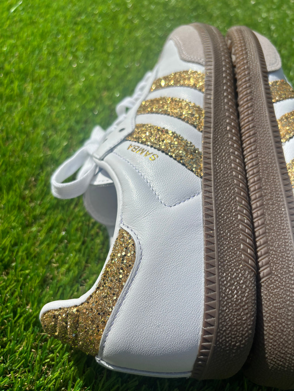Gold glitter Adidas samba OG sneakers.